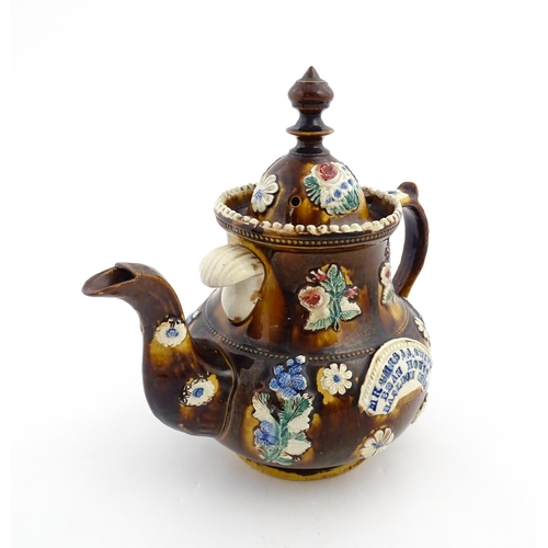 171 - A Victorian Measham bargeware teapot decorated with flowers and foliage, bearing plaque titled Mr & ... 