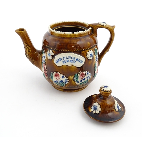 172 - A Victorian Measham bargeware teapot decorated with a basket of flowers and foliage, bearing plaque ... 