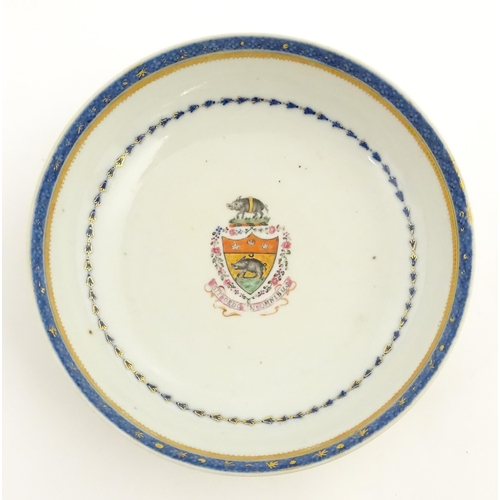 20 - A Chinese famille rose armorial cup and saucer, the armorial with boar in and above a shield, bearin... 