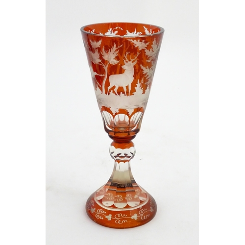 210 - A large Bohemian goblet with stag and woodland decoration. Approx. 9 3/4