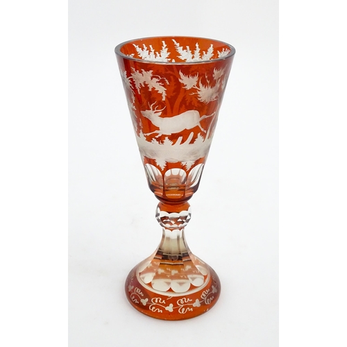 210 - A large Bohemian goblet with stag and woodland decoration. Approx. 9 3/4