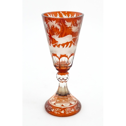 210 - A large Bohemian goblet with stag and woodland decoration. Approx. 9 3/4