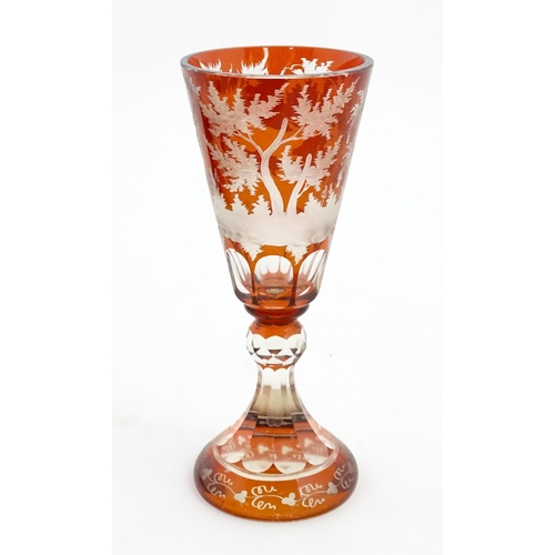 210 - A large Bohemian goblet with stag and woodland decoration. Approx. 9 3/4