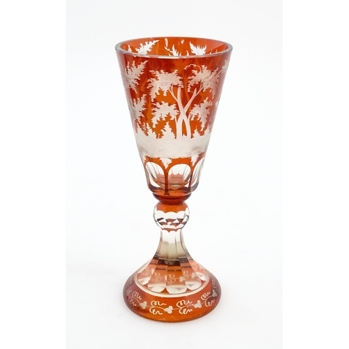 210 - A large Bohemian goblet with stag and woodland decoration. Approx. 9 3/4