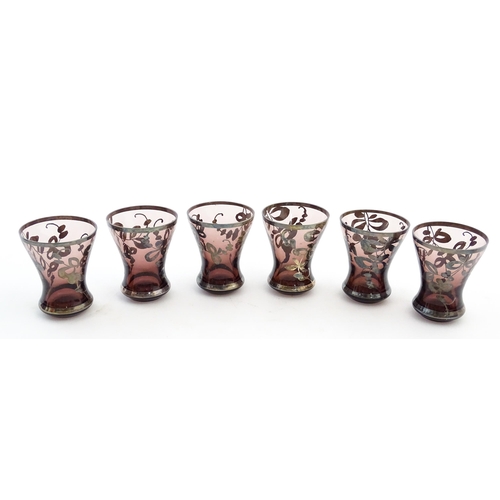 212 - An amethyst glass decanter and six tot glasses with silvered detail. Together with a further six gla... 