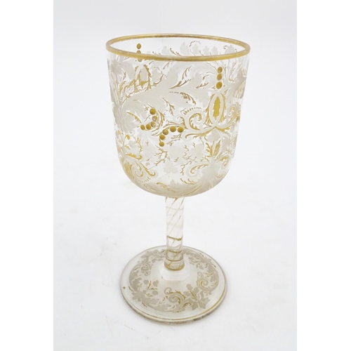 214 - A Continental glass goblet with etched detail and gilt highlights. Approx. 6 3/4