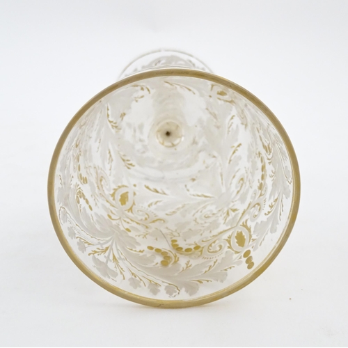 214 - A Continental glass goblet with etched detail and gilt highlights. Approx. 6 3/4