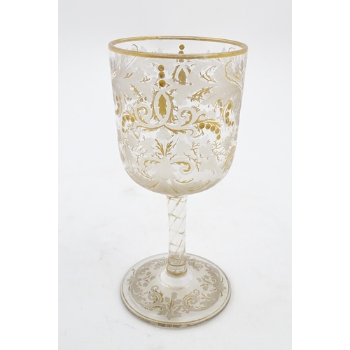 214 - A Continental glass goblet with etched detail and gilt highlights. Approx. 6 3/4