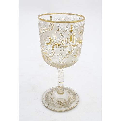 214 - A Continental glass goblet with etched detail and gilt highlights. Approx. 6 3/4