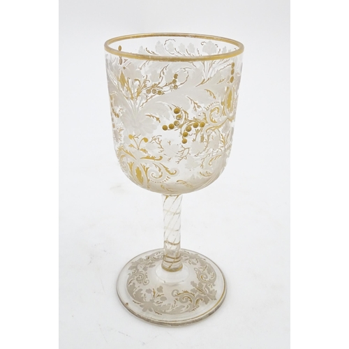 214 - A Continental glass goblet with etched detail and gilt highlights. Approx. 6 3/4