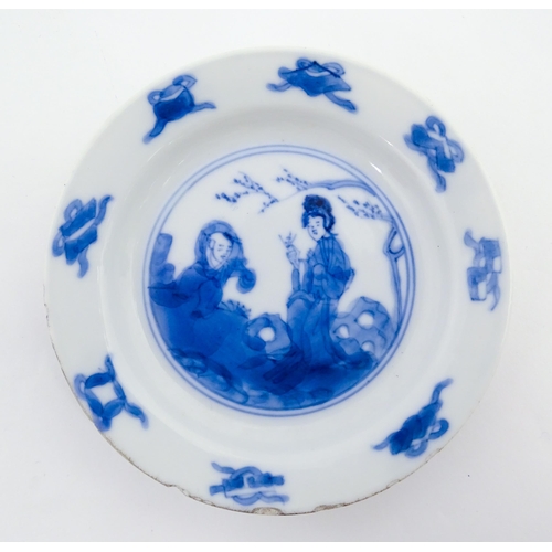 22 - A small Chinese blue and white dish decorated with figures in a landscape bordered by auspicious sym... 