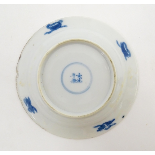 22 - A small Chinese blue and white dish decorated with figures in a landscape bordered by auspicious sym... 