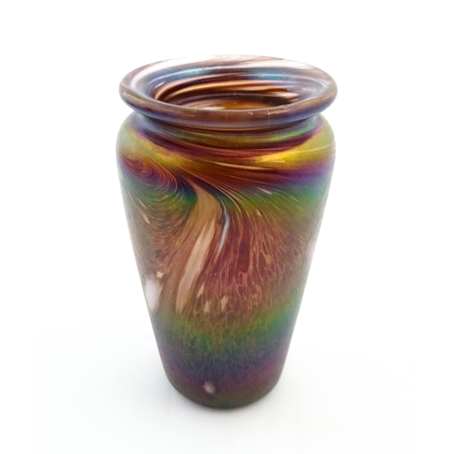 223 - An art glass vase of tapering form with iridescent detail. Approx. 5 3/4