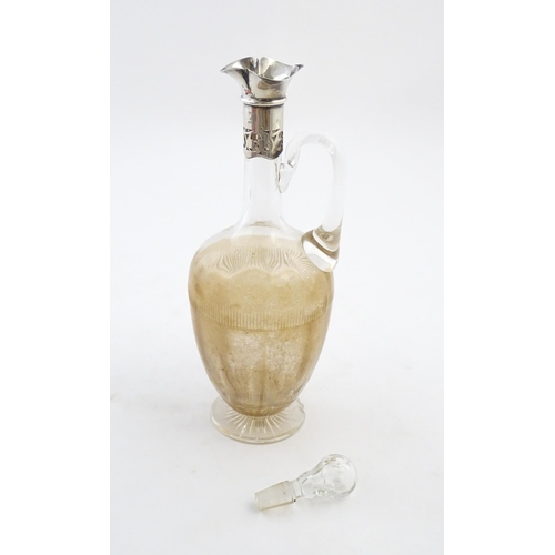 238 - A glass claret jug with silver collar hallmarked Birmingham 1927 maker William Hutton & Sons Ltd. Ap... 