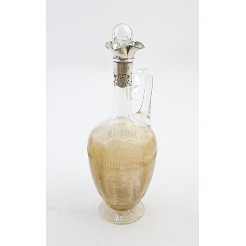 238 - A glass claret jug with silver collar hallmarked Birmingham 1927 maker William Hutton & Sons Ltd. Ap... 