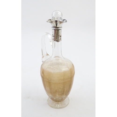 238 - A glass claret jug with silver collar hallmarked Birmingham 1927 maker William Hutton & Sons Ltd. Ap... 