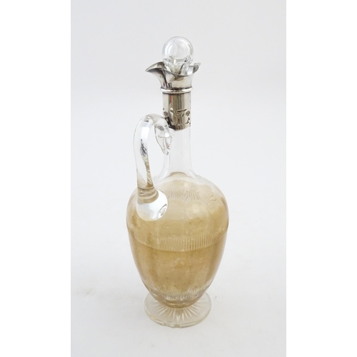 238 - A glass claret jug with silver collar hallmarked Birmingham 1927 maker William Hutton & Sons Ltd. Ap... 