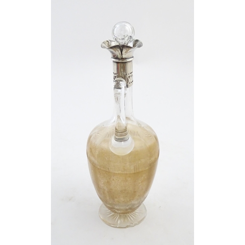 238 - A glass claret jug with silver collar hallmarked Birmingham 1927 maker William Hutton & Sons Ltd. Ap... 