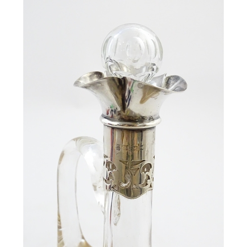 238 - A glass claret jug with silver collar hallmarked Birmingham 1927 maker William Hutton & Sons Ltd. Ap... 