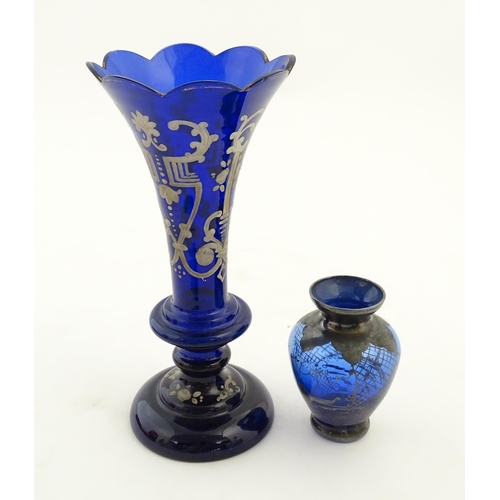 240 - Two items of blue glass, to include an early 20thC blue glass vase with enamel detail, together with... 