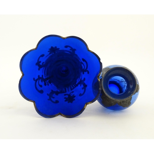 240 - Two items of blue glass, to include an early 20thC blue glass vase with enamel detail, together with... 