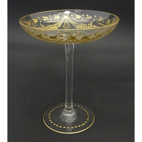 241 - A pedestal glass tazza / sweetmeat dish with etched floral swags and gilt detail.  Approx. 7