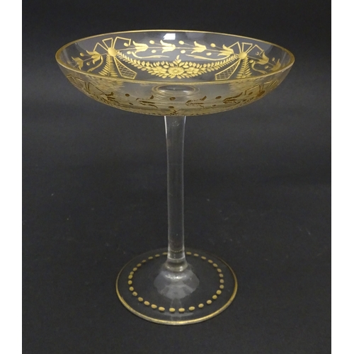 241 - A pedestal glass tazza / sweetmeat dish with etched floral swags and gilt detail.  Approx. 7