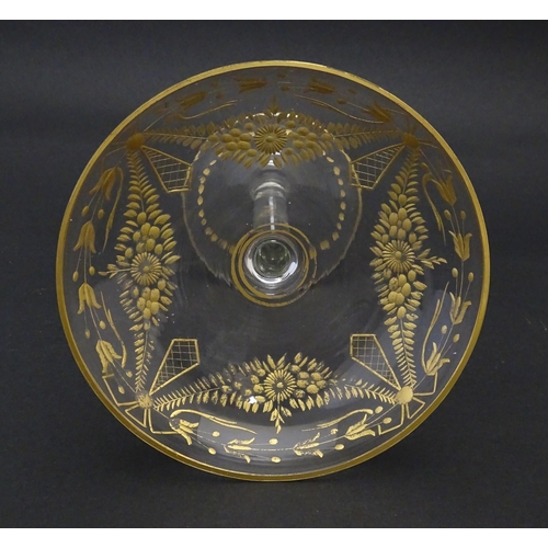 241 - A pedestal glass tazza / sweetmeat dish with etched floral swags and gilt detail.  Approx. 7