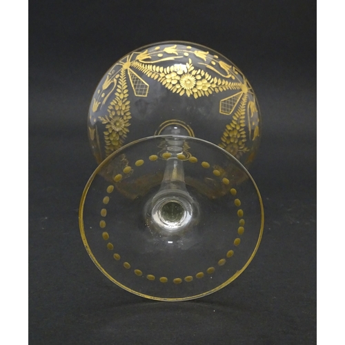 241 - A pedestal glass tazza / sweetmeat dish with etched floral swags and gilt detail.  Approx. 7