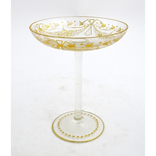 241 - A pedestal glass tazza / sweetmeat dish with etched floral swags and gilt detail.  Approx. 7