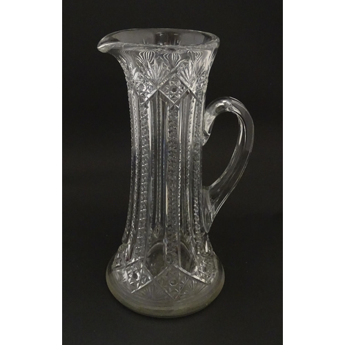 246 - A large cut glass water jug with loop handle. Approx. 12 3/4