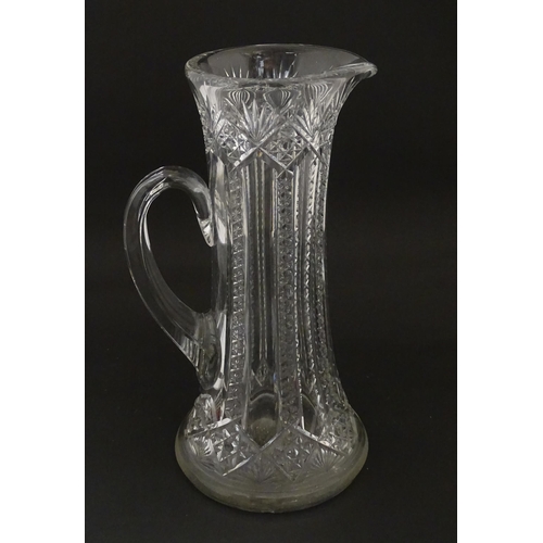 246 - A large cut glass water jug with loop handle. Approx. 12 3/4