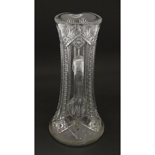 246 - A large cut glass water jug with loop handle. Approx. 12 3/4