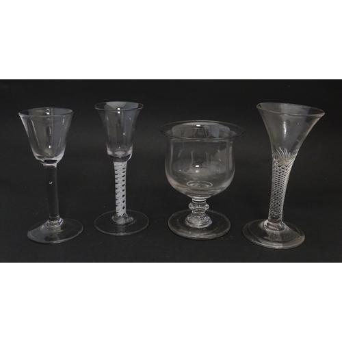 254 - Four assorted 18thC and later drinking glasses to include examples with air twist stems. Largest app... 