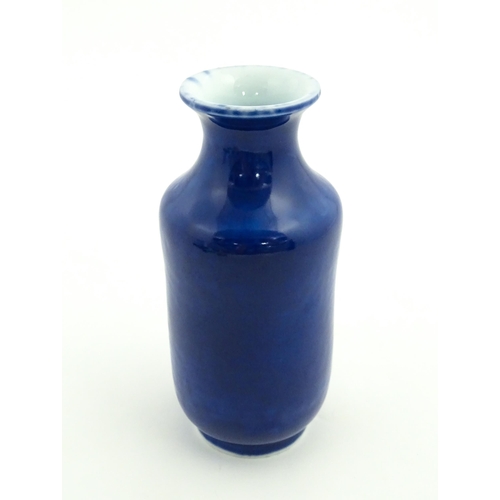 27 - A Chinese vase with a flared rim with a cobalt blue ground. Approx. 7 3/4