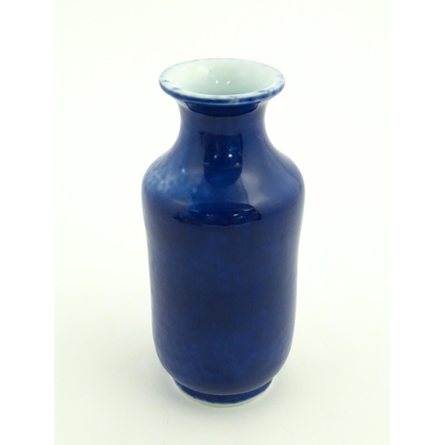 27 - A Chinese vase with a flared rim with a cobalt blue ground. Approx. 7 3/4