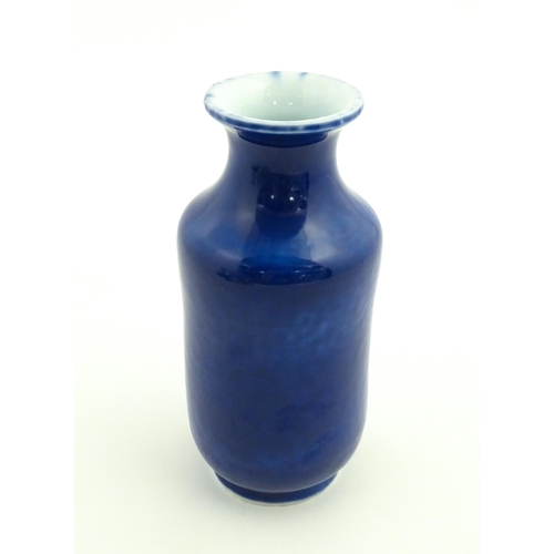 27 - A Chinese vase with a flared rim with a cobalt blue ground. Approx. 7 3/4