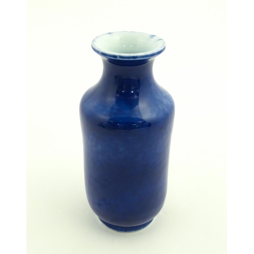 27 - A Chinese vase with a flared rim with a cobalt blue ground. Approx. 7 3/4