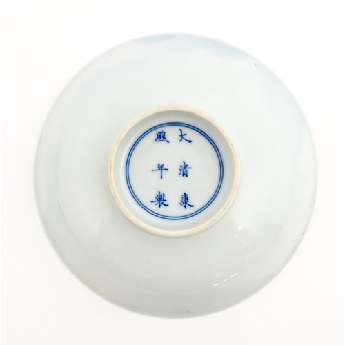 33 - A Chinese blue and white plate / dish decorated with figures on a bridge with lake and mountains bey... 