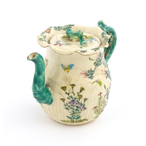 38 - A Japanese Satsuma teapot decorated with flowers, foliage and butterflies. Approx. 5