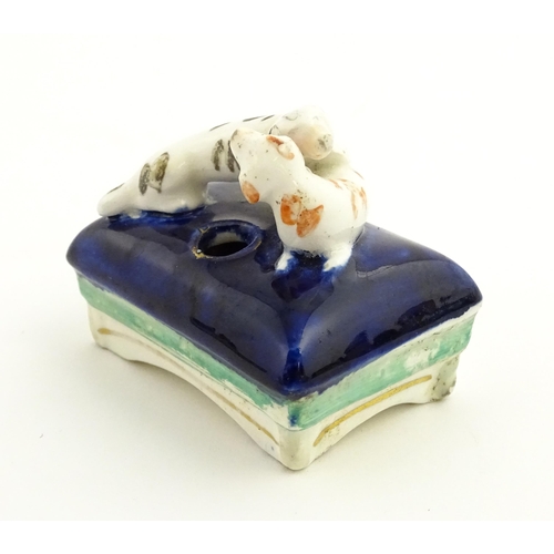 59 - A 19thC pen stand / inkwell modelled as two dogs on a cushion. Approx. 2 1/2