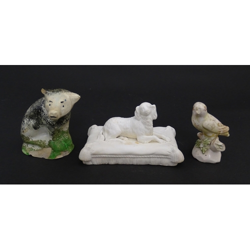 60 - A 19thC Minton style bisque / parian model of a recumbent Spaniel dog on a tasselled cushion. Togeth... 