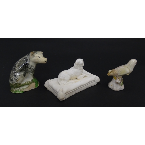 60 - A 19thC Minton style bisque / parian model of a recumbent Spaniel dog on a tasselled cushion. Togeth... 