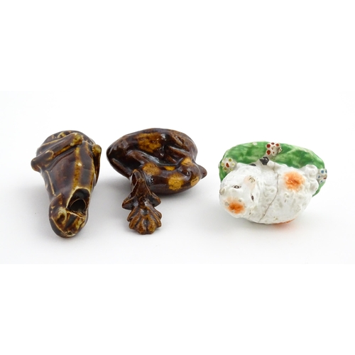 61 - A treacle glazed novelty bird call whistle formed as a frog / toad. Together with a treacle glazed m... 