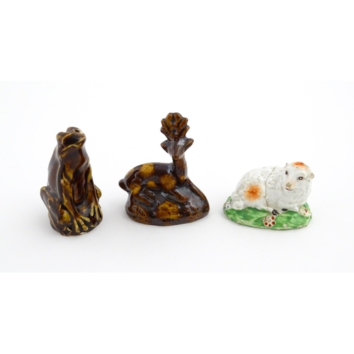 61 - A treacle glazed novelty bird call whistle formed as a frog / toad. Together with a treacle glazed m... 