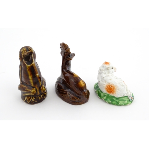 61 - A treacle glazed novelty bird call whistle formed as a frog / toad. Together with a treacle glazed m... 