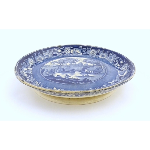 65 - A blue and white footed plate decorated with a view of Nuneham Park, Oxfordshire with wild rose bord... 