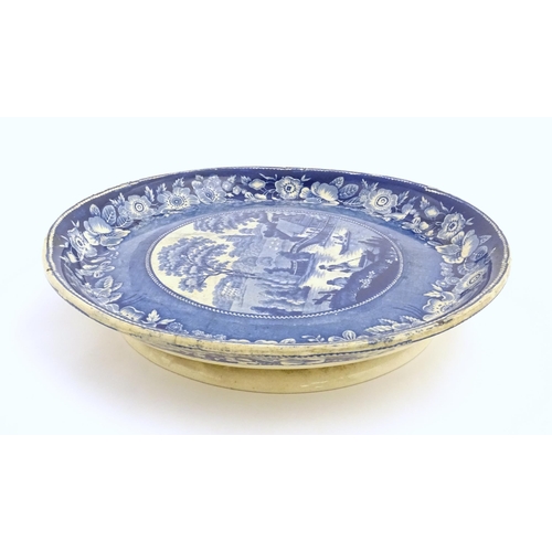 65 - A blue and white footed plate decorated with a view of Nuneham Park, Oxfordshire with wild rose bord... 