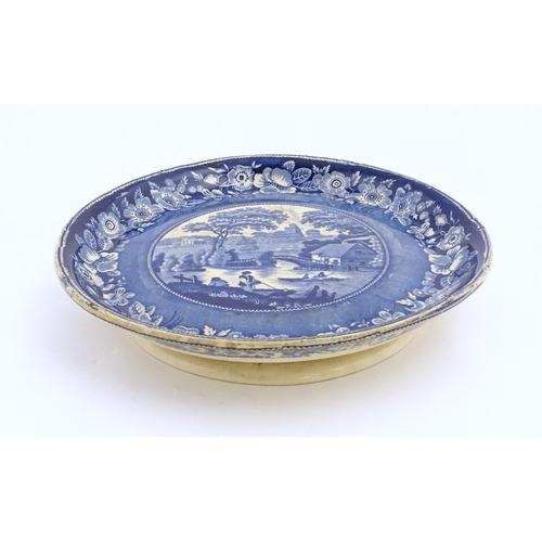 65 - A blue and white footed plate decorated with a view of Nuneham Park, Oxfordshire with wild rose bord... 