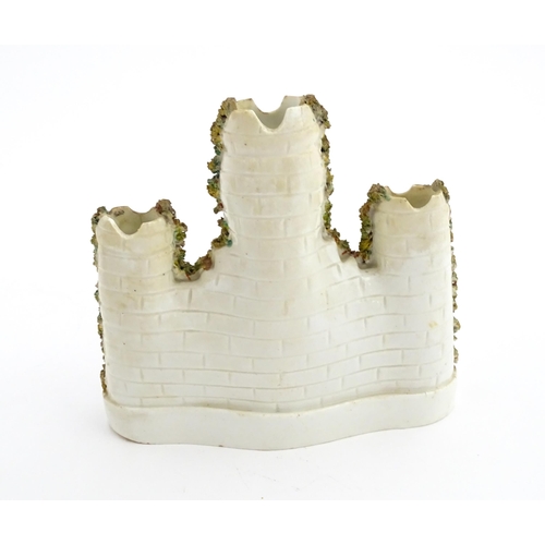 67 - A Staffordshire pottery spill vase modelled as a castle with castellated turrets. Approx. 6 1/2